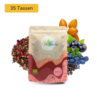 Der Geheimtipp Beerenwald Tee Verpackung aus Papier mit losem Johannisbeere Heidelbeere Hibiskus Früchtetee im Hintergrund