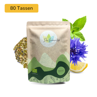 Der Geheimtipp Hängematte Tee Verpackung aus Papier mit losem Minze Zitrone Kornblume Kräutertee im Hintergrund